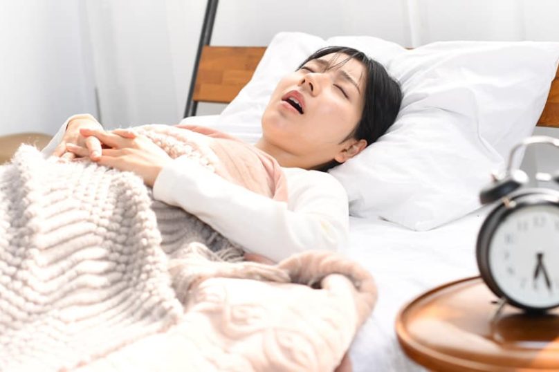 An image depicting an Asian woman snoring