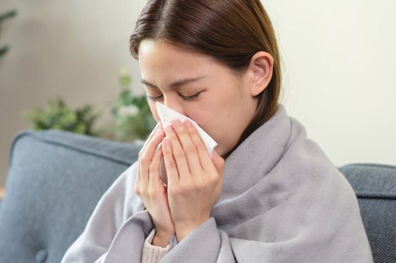 Woman experiencing nasal congestion and sinus discomfort